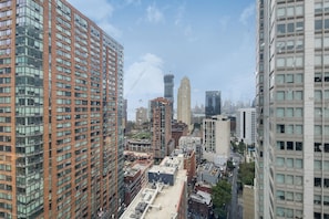 A high-rise urban area with multiple buildings, including a prominent red-brick structure and a modern glass skyscraper.