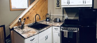 The Loft King Room w/ full kitchen in historic Carriage House building.