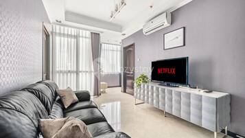 Apartamento, 1 habitación, vistas a la ciudad | Zona de estar | Smart TV de 43 pulgadas con canales por cable, una televisión