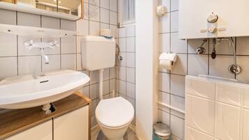 A bathroom with a sink, toilet, and bathtub.