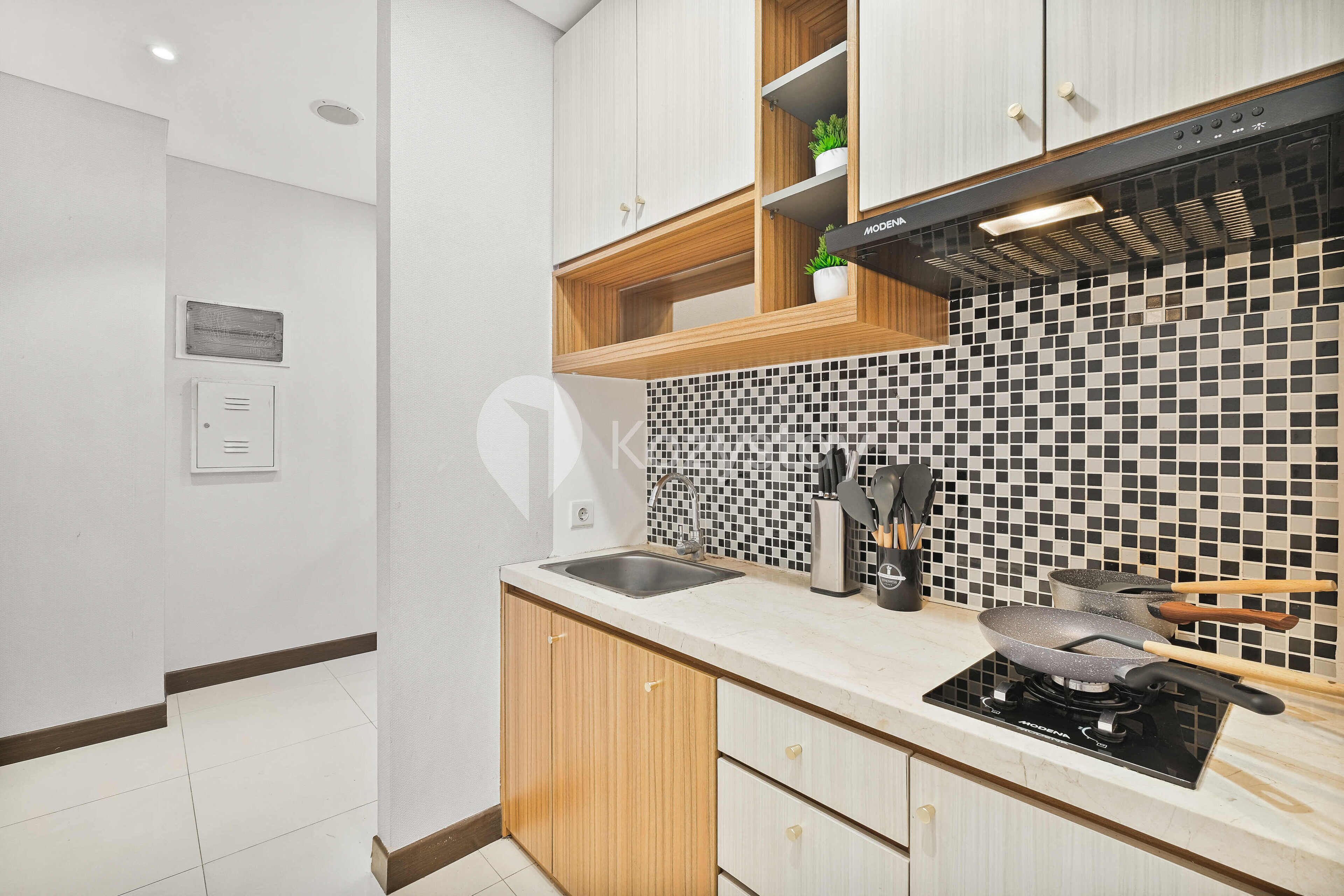A modern kitchen with a built-in stove, a sink, and wooden cabinets.