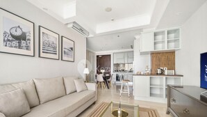 A modern living room with a sofa, a coffee table, and framed pictures on the wall.