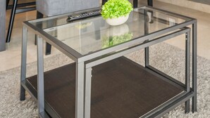 A modern kitchen with a glass-top dining table, two pendant lights, and a built-in oven. - QUARTER by Kozystay (Jakarta)