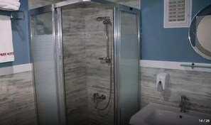 A glass-enclosed shower with a handheld showerhead and a handheld faucet. - Park Otel (Kayseri)