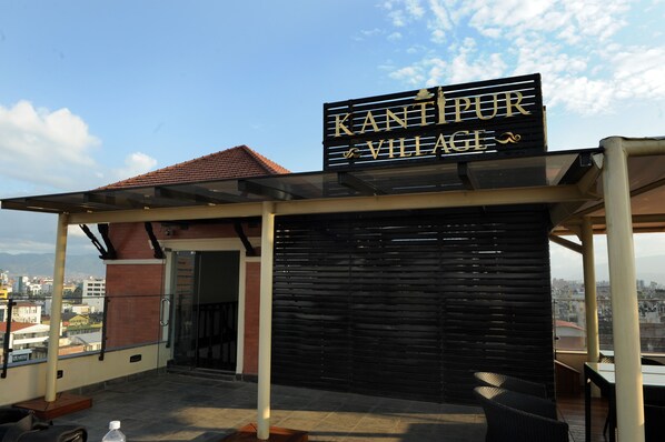 A rooftop terrace with a sign reading "KANTIPUR VILLAGE".
