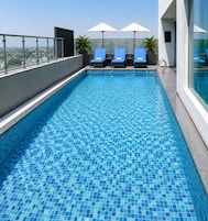 Outdoor pool, open 8:00 AM to 7:00 PM, pool umbrellas