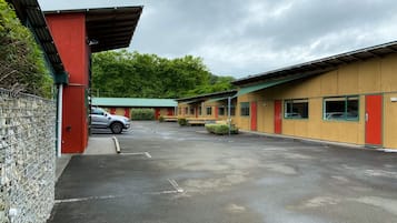Simple, functional design with single-story buildings and a green awning over the entrance.