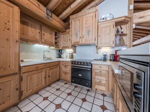Functional kitchen with stove, sink, and appliances.