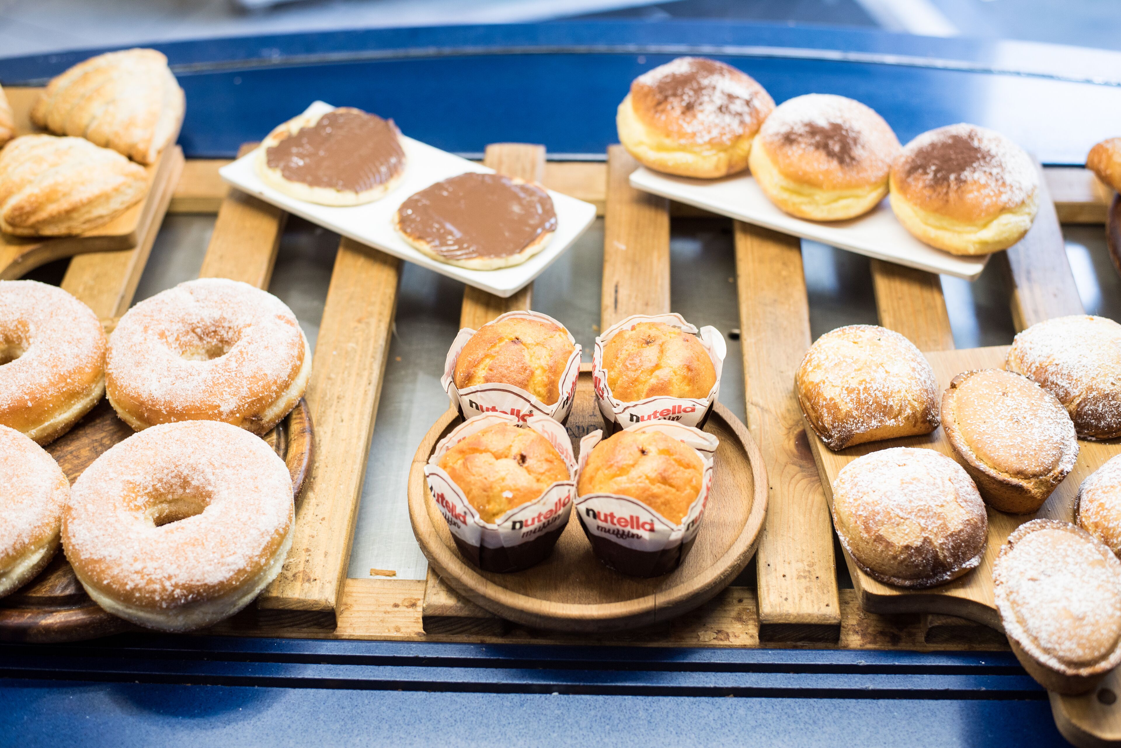 A variety of pastries displayed on wooden boards.
