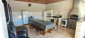 A compact kitchen with a dining table, a built-in oven, and a microwave. - Swimming pool with heating temp 30º to 34º, Air Cond. WiFi, New House (SP)