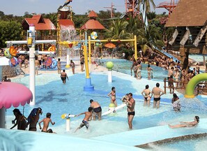 A water park with multiple water slides and play structures. - Heated pool (30º to 34º), air conditioning, Wi-Fi, new house (SP)