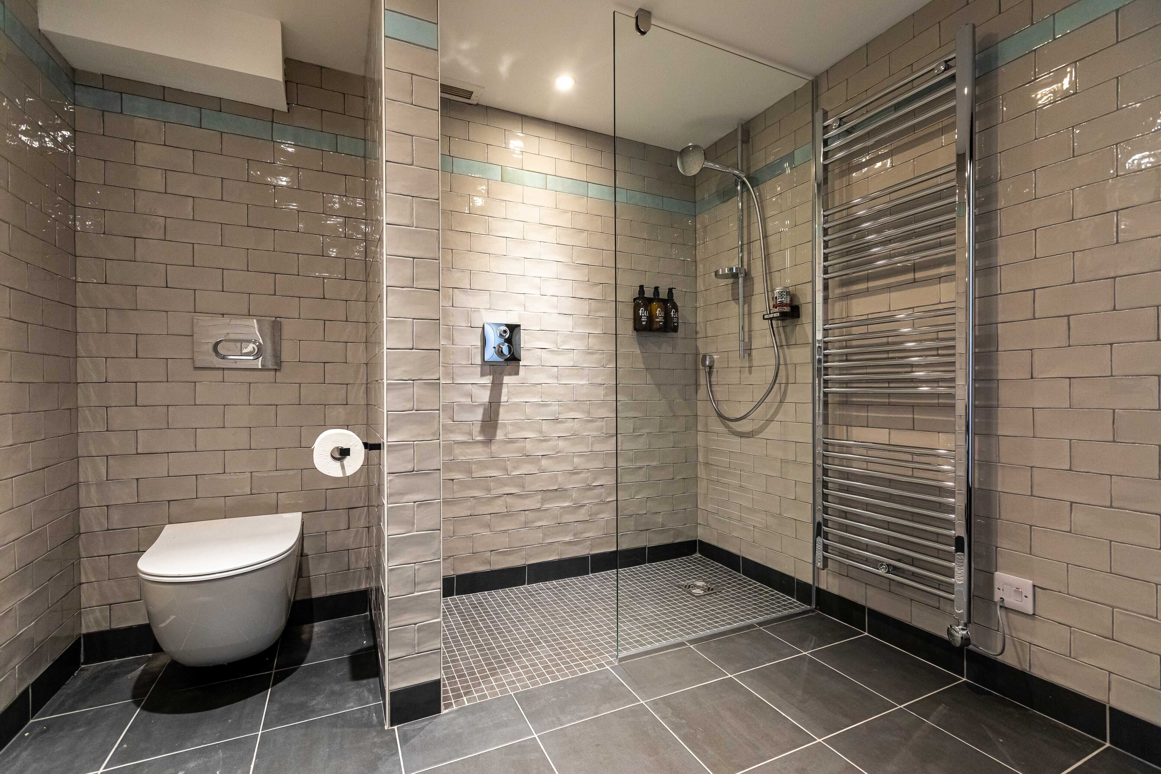 captain's suite | bathroom | shower, designer toiletries, hair dryer, bathrobes