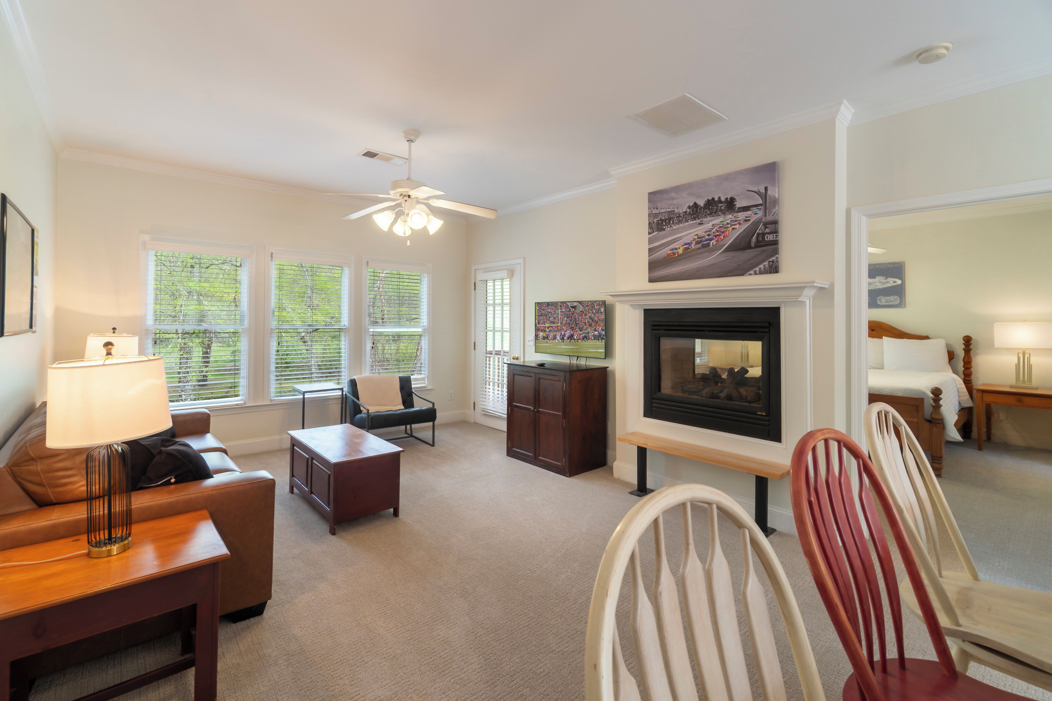 A living room with a fireplace, a sofa, a coffee table, and a television.