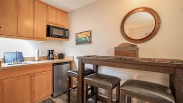 Fridge, microwave, coffee/tea maker, cookware/dishes/utensils