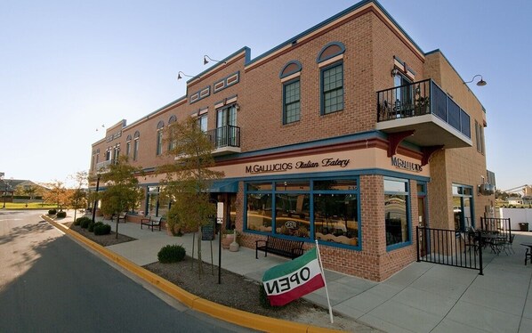 A two-story building with a storefront labeled 'M.Gallucios Italian Eatery.'