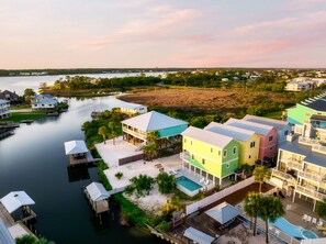 A waterfront property with multiple buildings, docks, and a swimming pool.