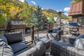 A terrace with wicker furniture, a barbecue grill, and a view of a mountainous landscape. - Lift 8 Chalet - Prime location! 1/2 Block from Gondola! Ski-In-Ski-Out!! (Telluride)