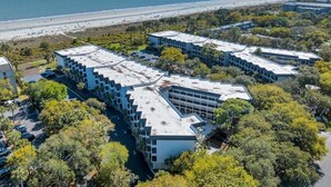 A modern hotel complex with multiple buildings, surrounded by trees and a beach view. - Soak Up the Ocean Air Seaside Villa Stay Near the Sand (Hilton Head Island)