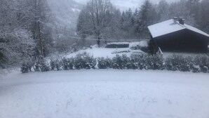 Un paysage enneigé avec une cabane et des arbres.