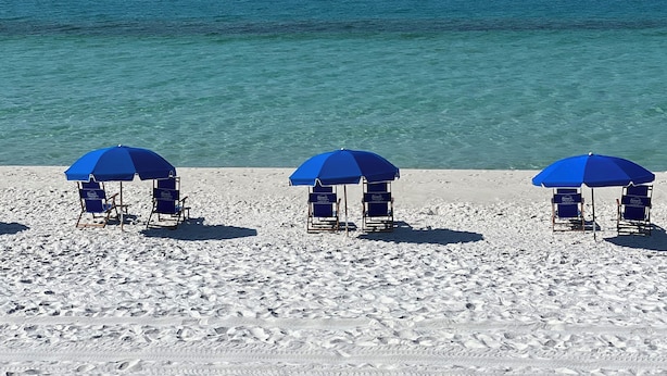 A beach with three blue umbrellas and beach chairs. - Amazing Sunsets, Sugar White Sand, Gulf Front (Fort Walton Beach)