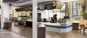 Relax in a stylish space with a central counter, bar stools, and high chairs, offering a view of the outdoors.