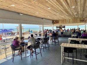 Enjoy a meal with a view of the ocean from our beachfront restaurant's outdoor dining area.