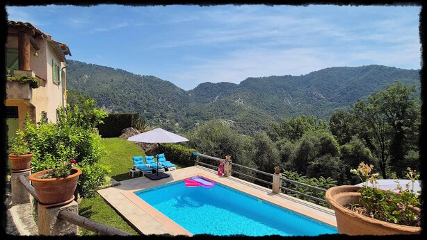 A swimming pool with a view of mountains, a patio with chairs, and potted plants. - Secluded private villa with pool close to the mountains, just 25 mins from Nice (Coaraze)