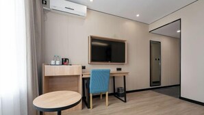 A modern hotel room with a desk, chair, and a round table. - GreenTree Inn Express Hotel (Shanghai Songjiang Sports Center Subway Station) (Shanghai)