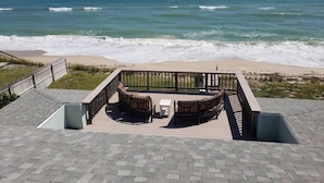 A deck with outdoor seating overlooking a beach and ocean. - Rustic Beach Front Home - 6 Bedrooms - Private Beach Access - Large Groups (Melbourne Beach)
