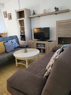 A living room with a sofa, a coffee table, a TV, and a cabinet. - LUXURY SEMI-DETACHED HOUSE IN VERA PLAYA 200 M FROM THE SEA (Vera)