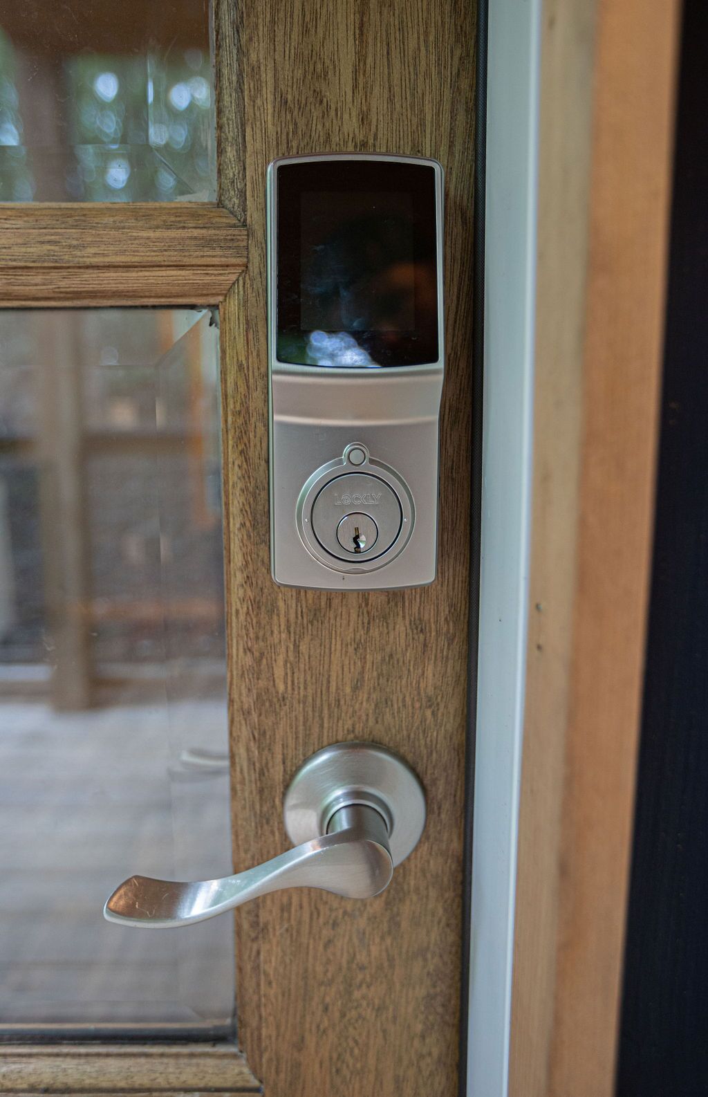 A door with a modern electronic lock and a keyhole.
