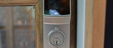 A door with a modern electronic lock and a keyhole.