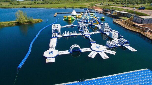 An aerial view of a water park with various water play structures and a dock area. - Idyllic 2 bedroom Canal facing Cottage in Hopwas (Hopwas)