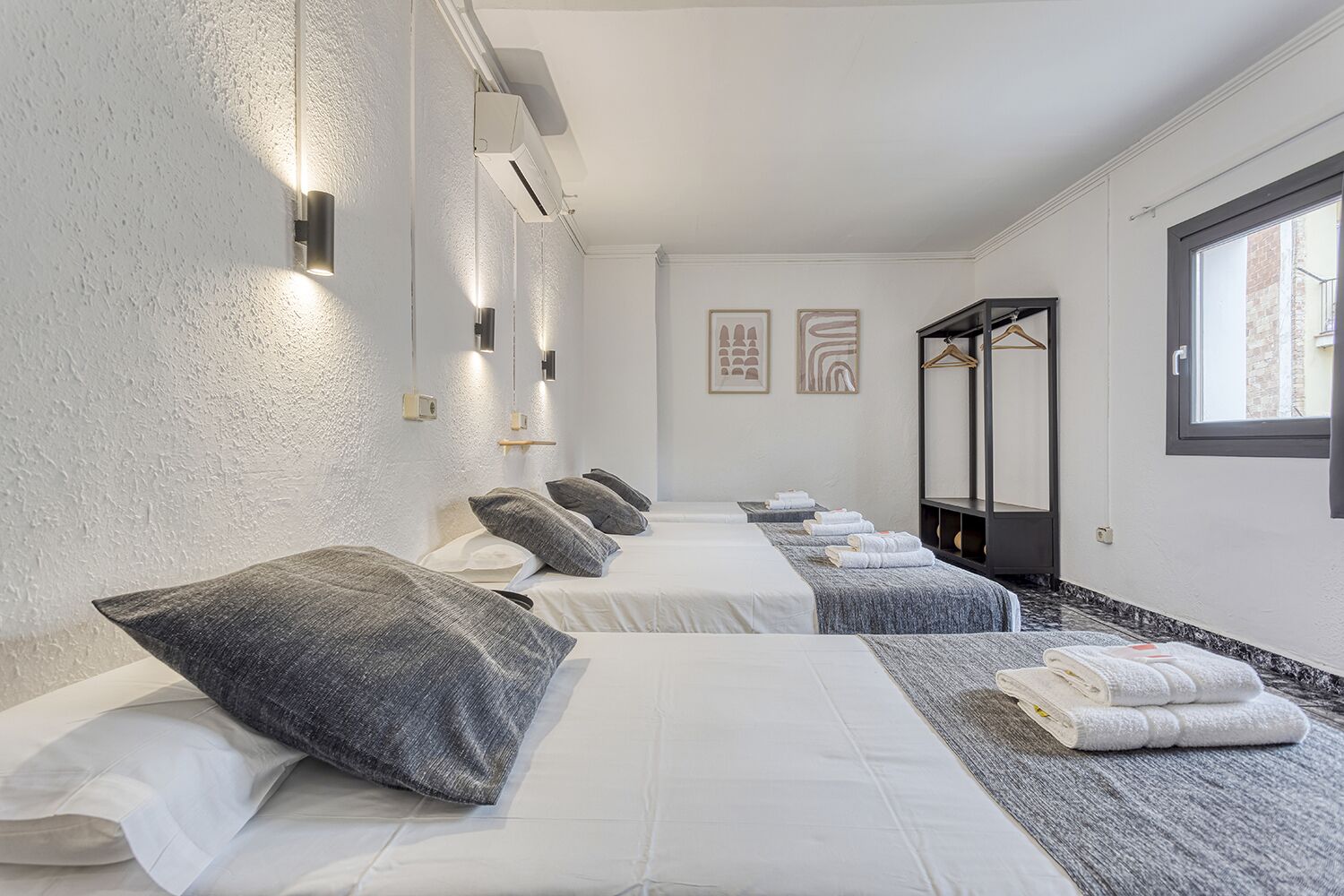 A spa room with two beds, towels, and a mirror.