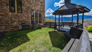 A stone building with a gazebo, a barbecue area, and a view of mountains. - Mountain Views, Hot Tub & Walk to Summer Concerts (Crested Butte)