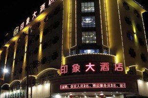 A hotel with illuminated signage, multiple floors, and a prominent entrance.