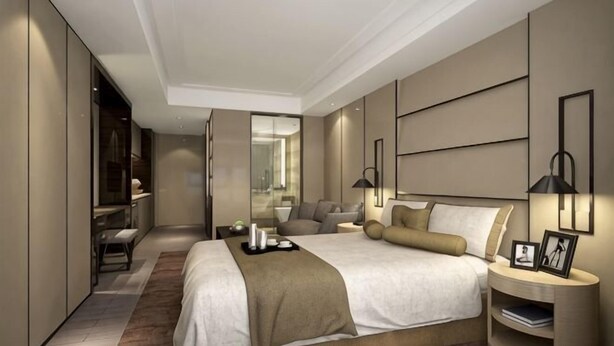 A modern hotel room with a large bed, bedside tables, a mirror, and a wardrobe. - Jielv Hotel (Puning)