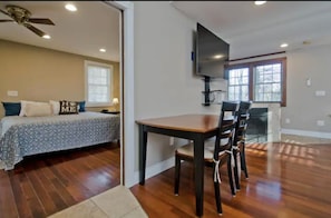 Relax in this spacious living area with a large bed, dining space, and cozy fireplace.