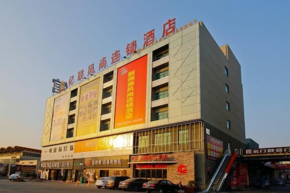A multi-story building with signage indicating it is a hotel.
