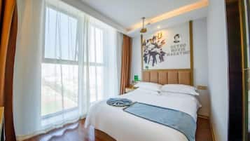 A hotel room with a large bed, a nightstand, a wall clock, and a window with curtains.