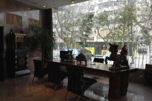 A modern interior with a long table, chairs, and a decorative sculpture.