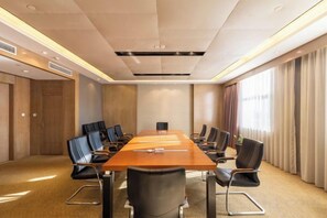 A conference room with a long table, multiple chairs, and a carpeted floor. - Panshan Yinlong Hotel (Panshan)