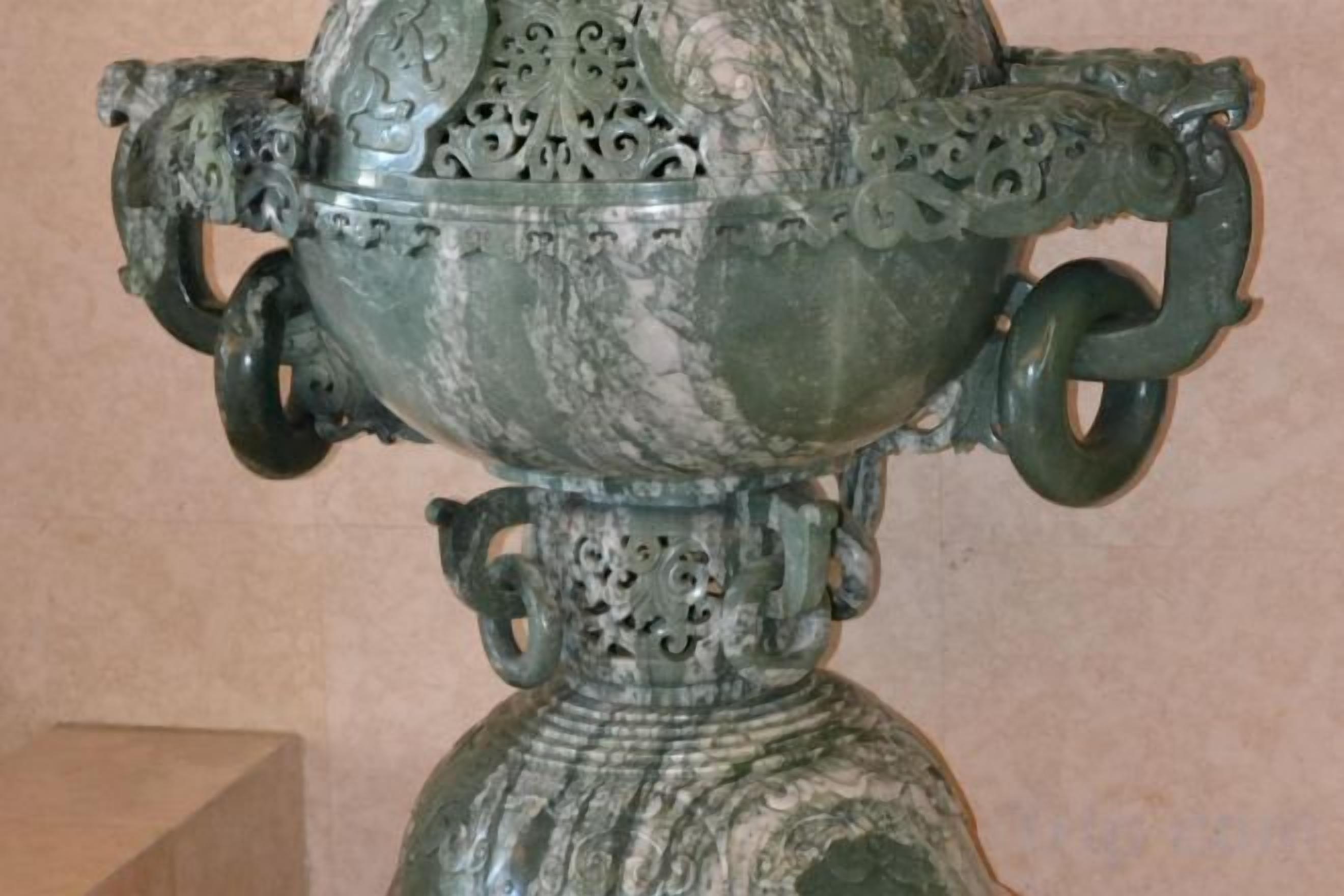 A decorative urn with intricate patterns and handles.