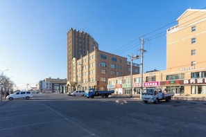 A multi-story building with commercial establishments on the ground floor, including a hotel and various shops. - Panshan Yinlong Hotel (Panshan)