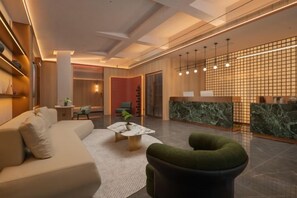 A modern lobby with a reception desk, seating area, and a reception counter. - Yueyi Hotel (Huaihua Sports Center) (Huaihua)