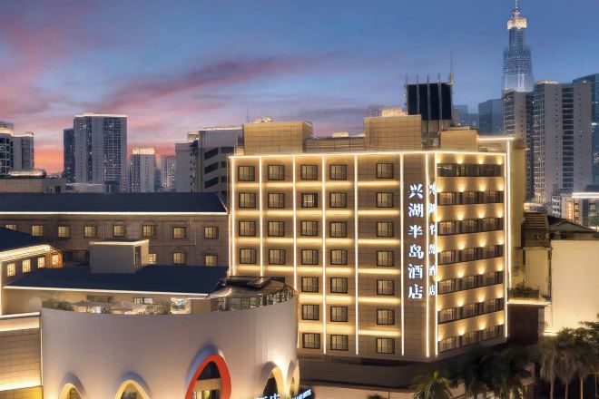 A hotel with multiple floors, a prominent circular logo, and a modern design.