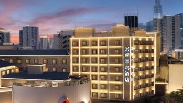 A hotel with multiple floors, a prominent circular logo, and a modern design.