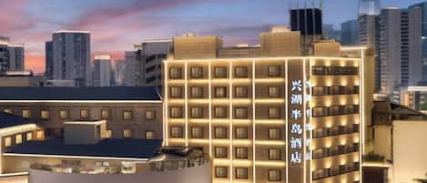 A hotel with multiple floors, a prominent circular logo, and a modern design.