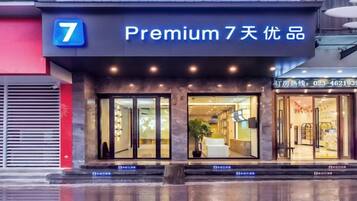 L’entrée d’un hôtel, avec une enseigne indiquant qu’il propose une offre « Premium » valable 7 jours.