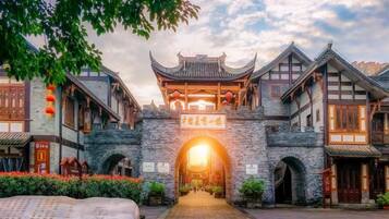 A traditional Chinese gate with a clear pathway leading through it, surrounded by buildings with traditional architecture.